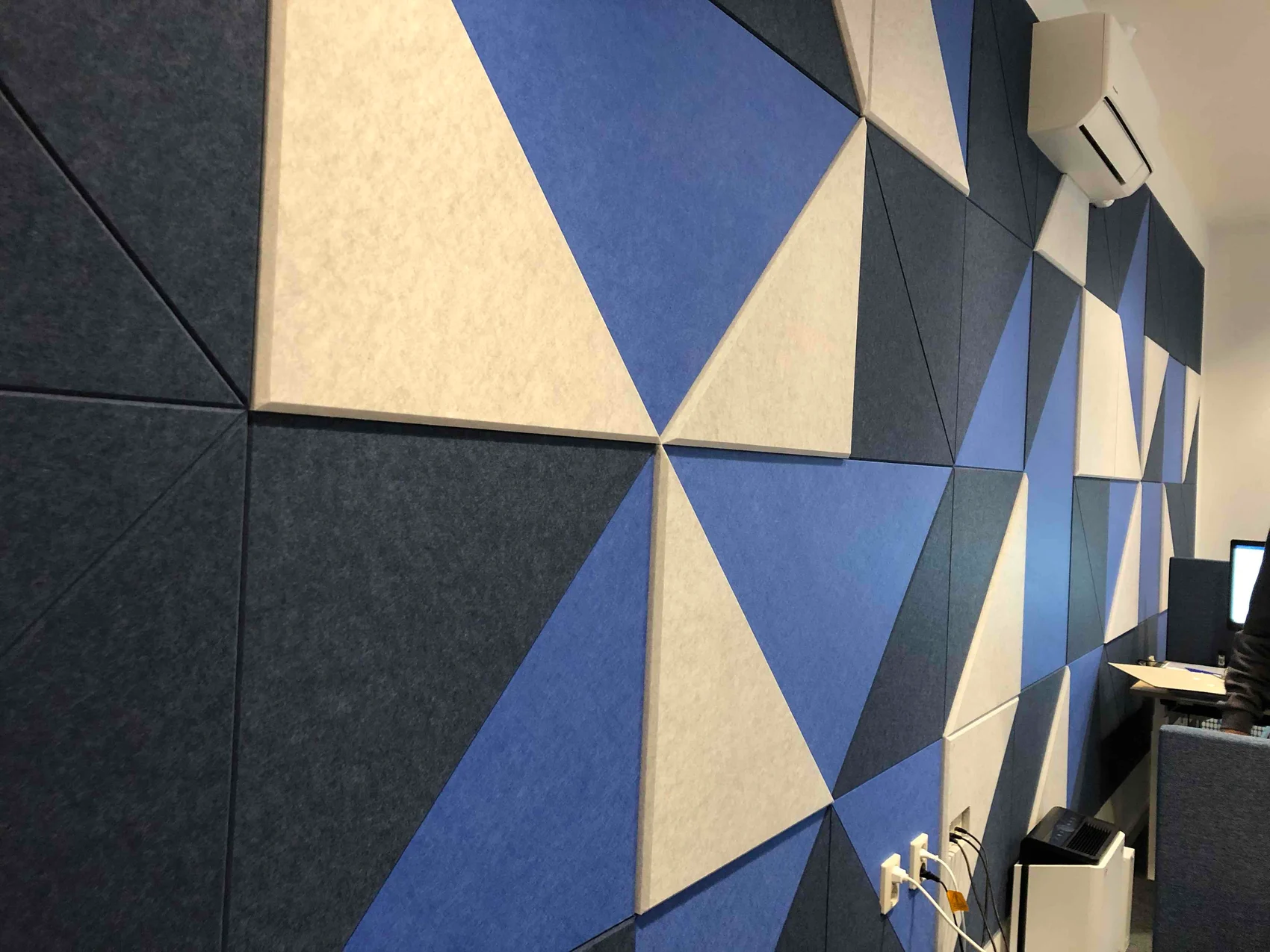 Felt wall with geometric blocks in blue, sand and charcoal