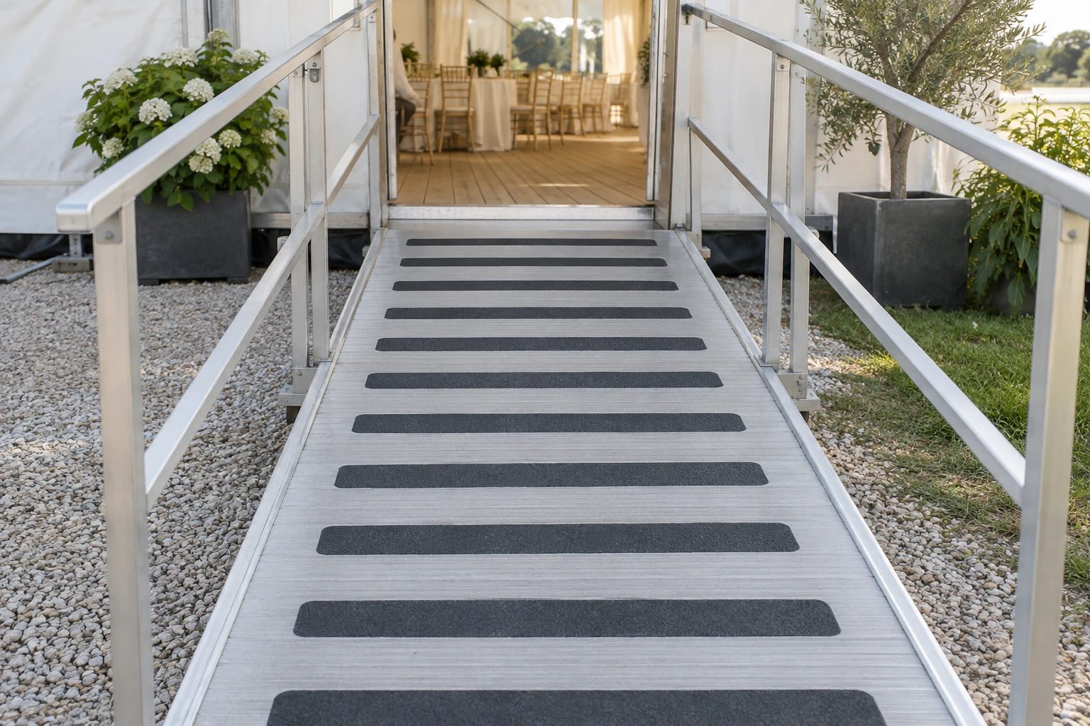 Temporary access ramp with anti-slip strips at an event pavilion
