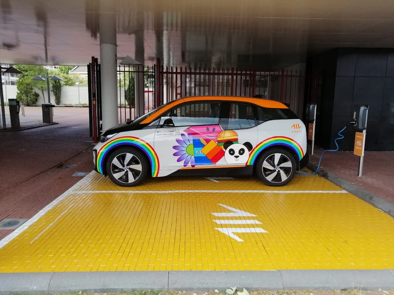 BMW i3 with colourful full colour graphics and an orange roof.