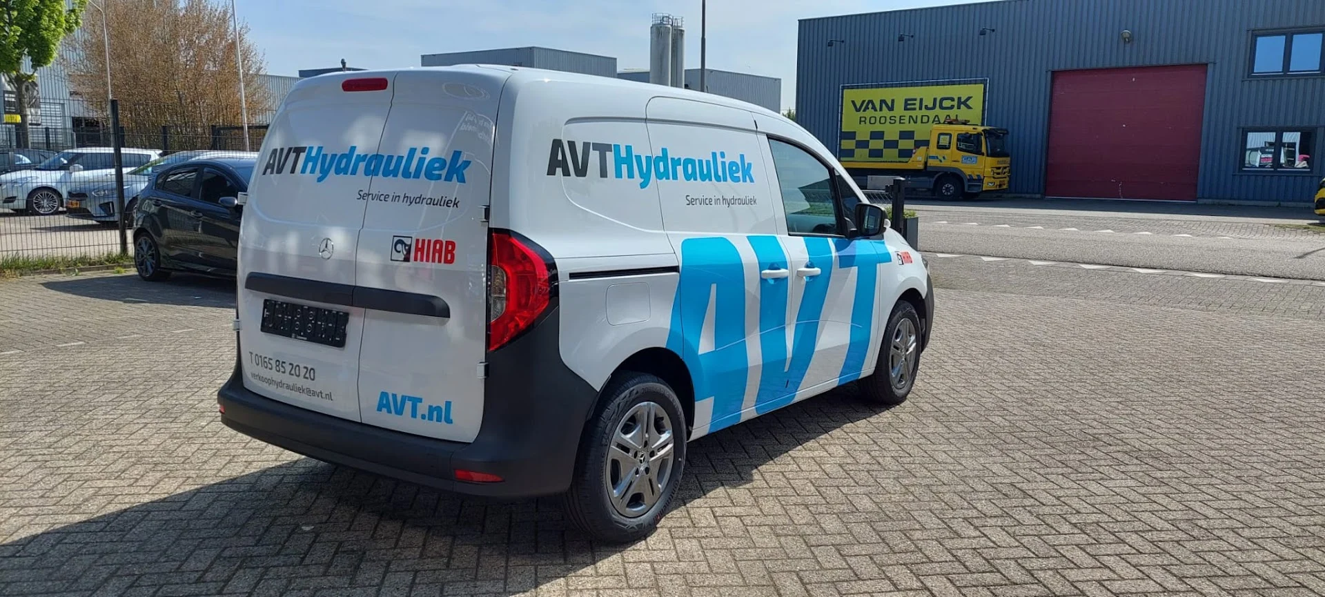 White Mercedes van with blue AVT Hydrauliek graphics.