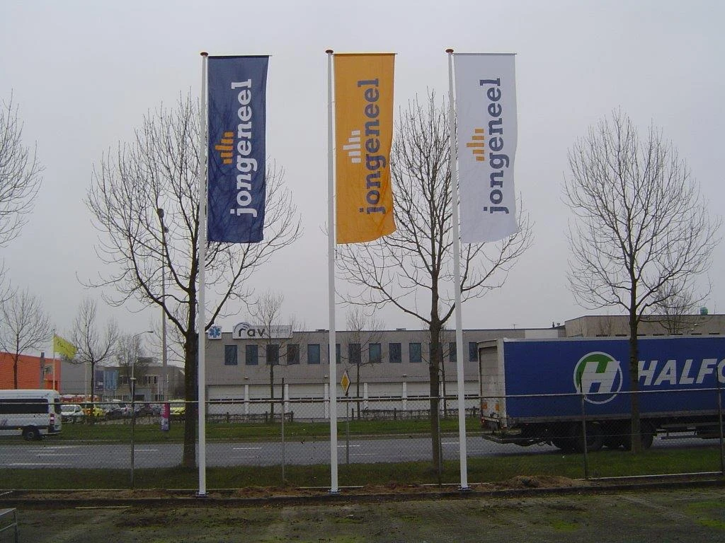Three vertical flags with banner arms on business premises