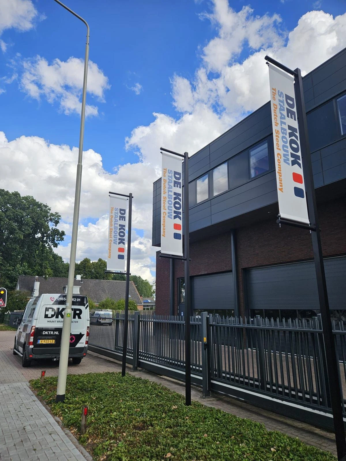 Row of freestanding pole banners outside business premises