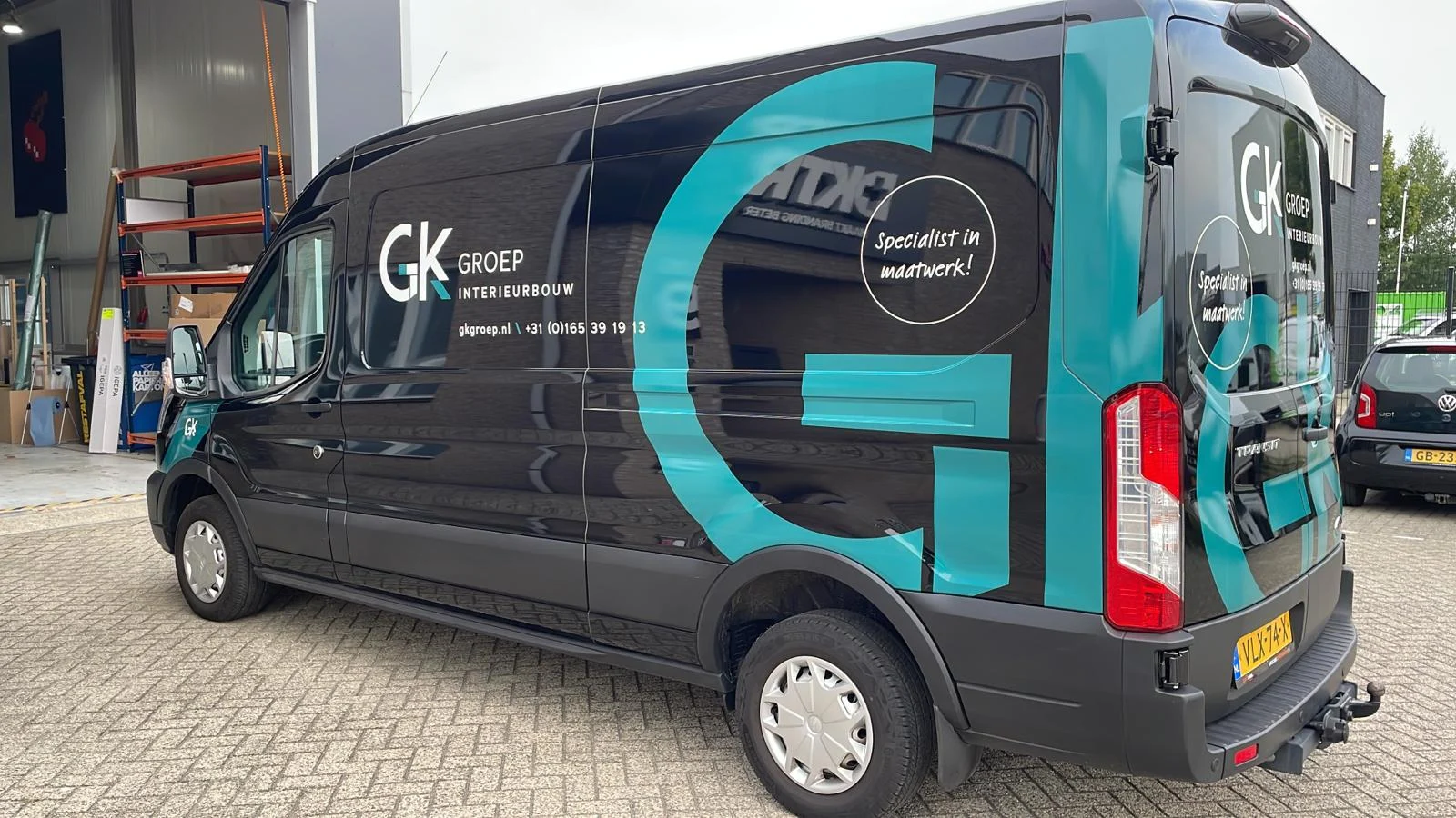 GK Groep van with large turquoise brand graphics.
