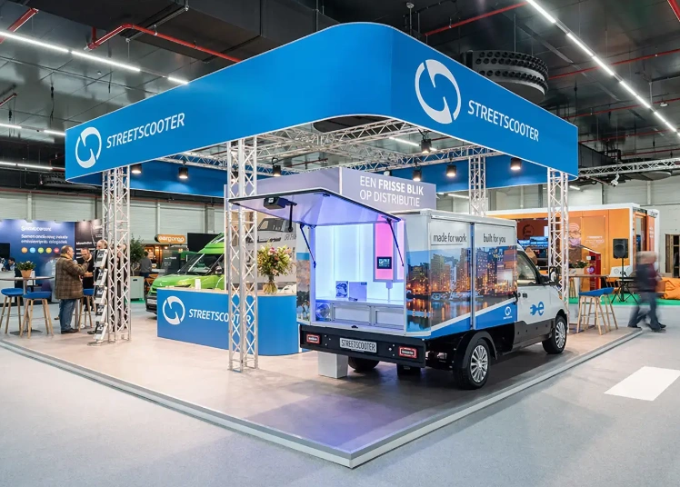 StreetScooter exhibition stand with blue overhead signage and an electric delivery vehicle at Horecava