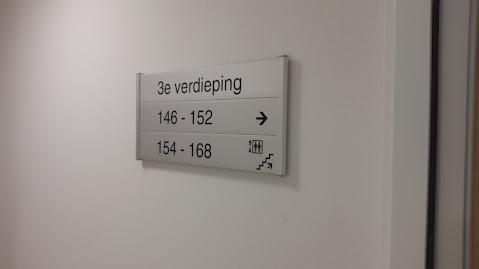 Our project photo of a third-floor sign with room numbers, a directional arrow and lift and stair symbols