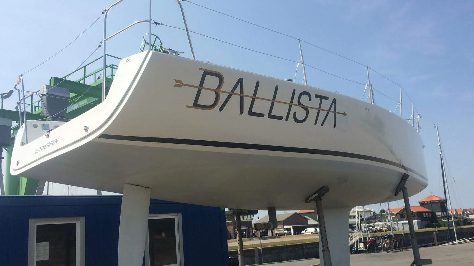 Ballista boat name with a gold arrow on the stern of a sailing boat.
