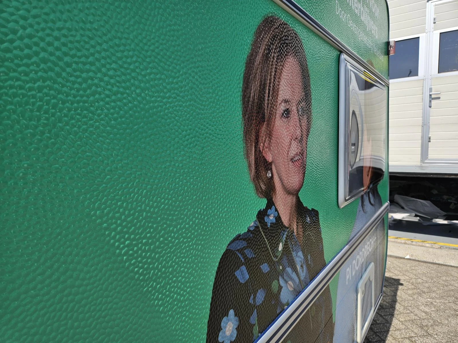 Close-up of printed film on a caravan panel with visible texture.