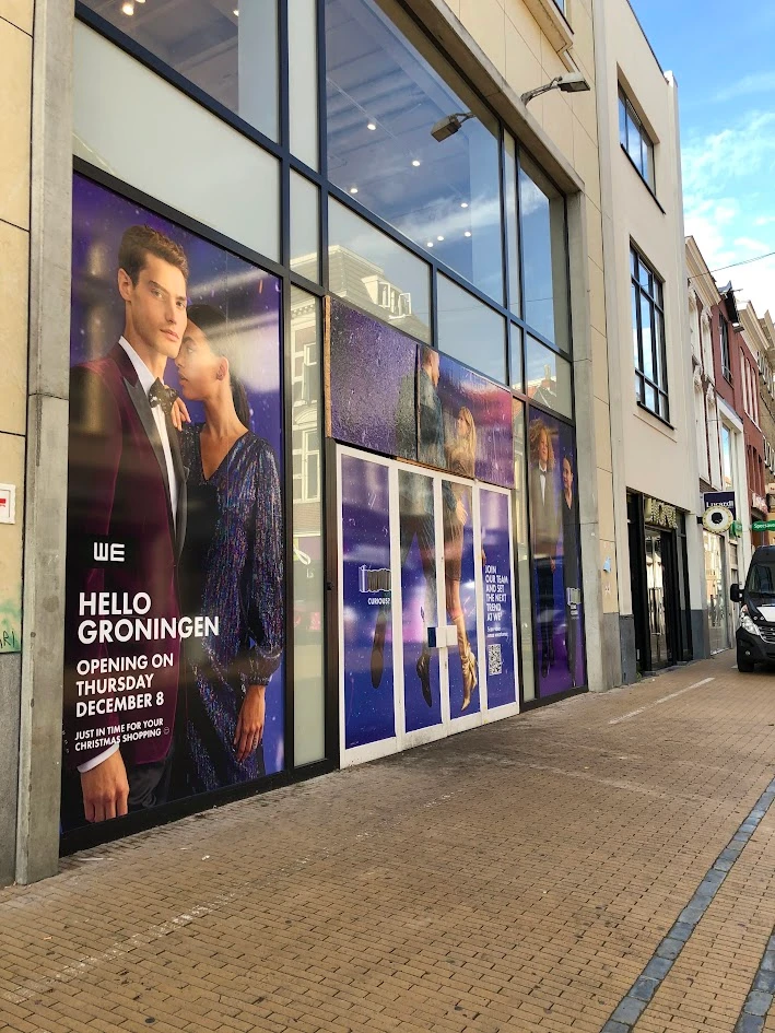 Shopfront with colourful window graphics across several panes