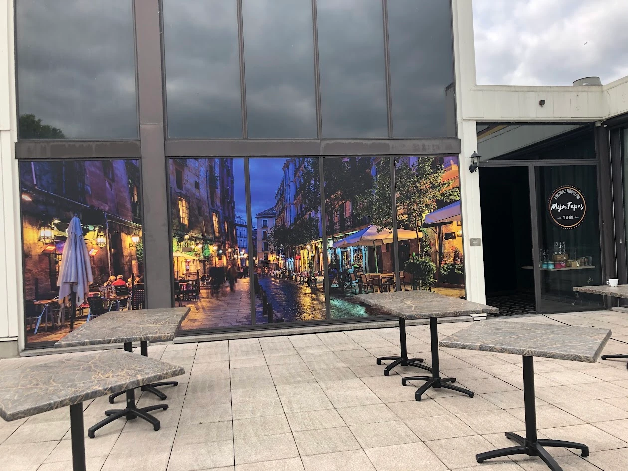Restaurant windows with a continuous full-colour image of an illuminated street