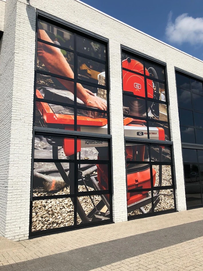 Glazed business facade with a large full-colour tool print