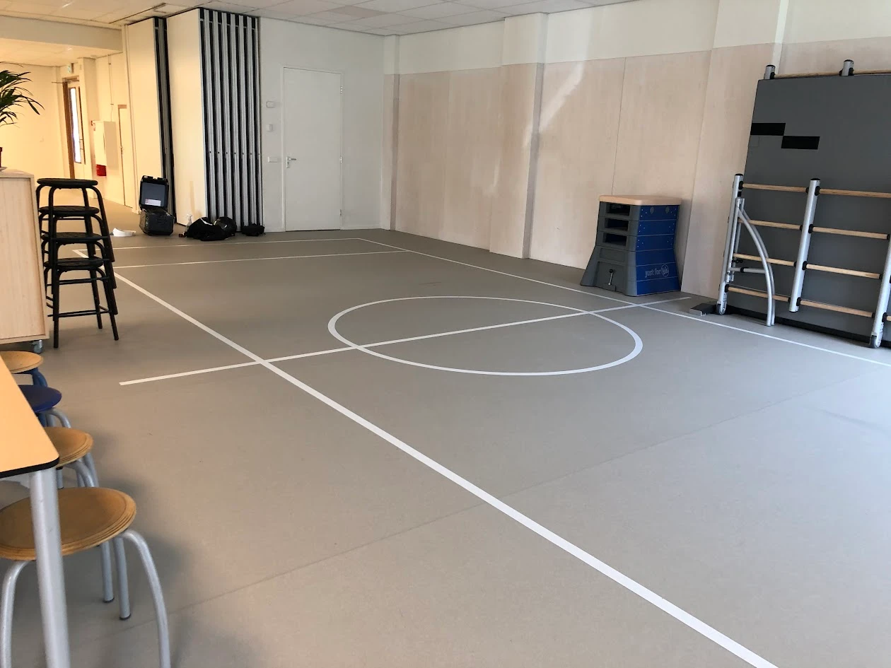White sports lines and a centre circle in a multipurpose indoor space