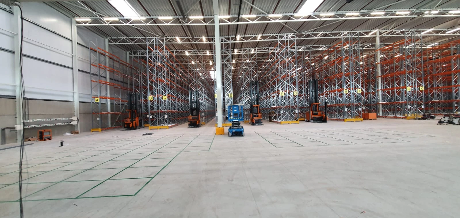 Green storage bays on a warehouse floor