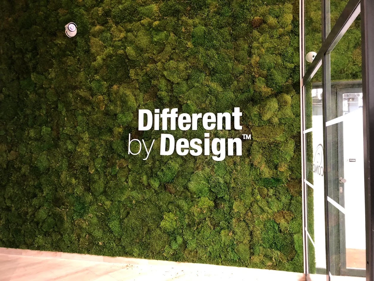 White letters on a moss wall