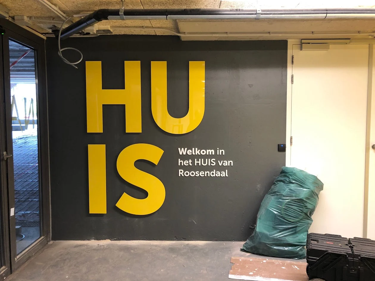 Large yellow letters on an entrance wall