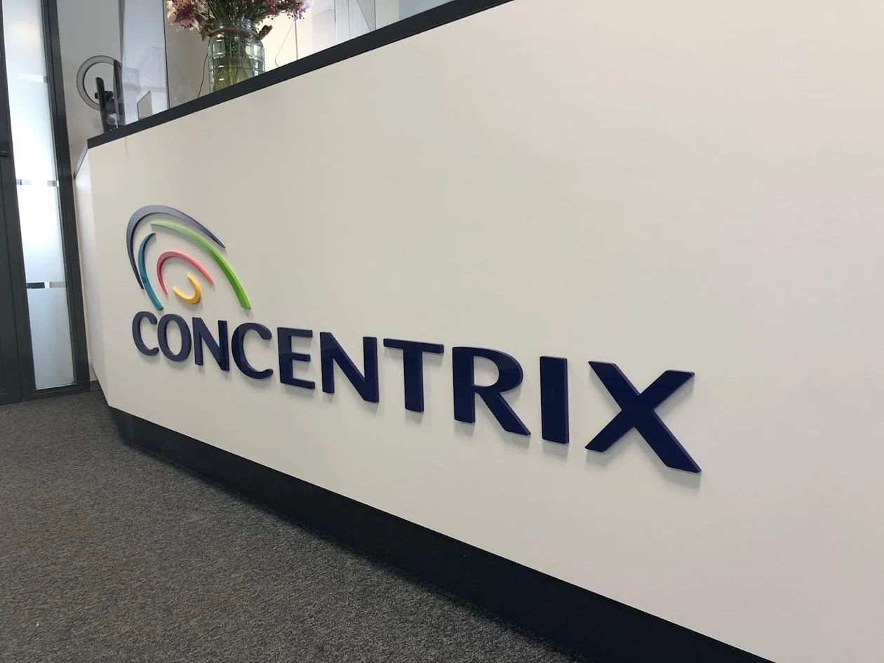 Dark blue logo on a white reception desk