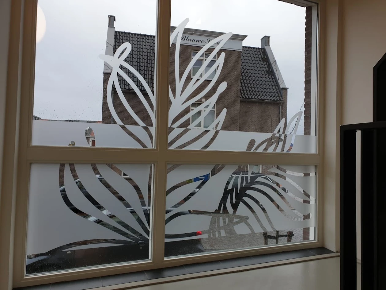 Leaf shapes cut from frosted film on clear window glass