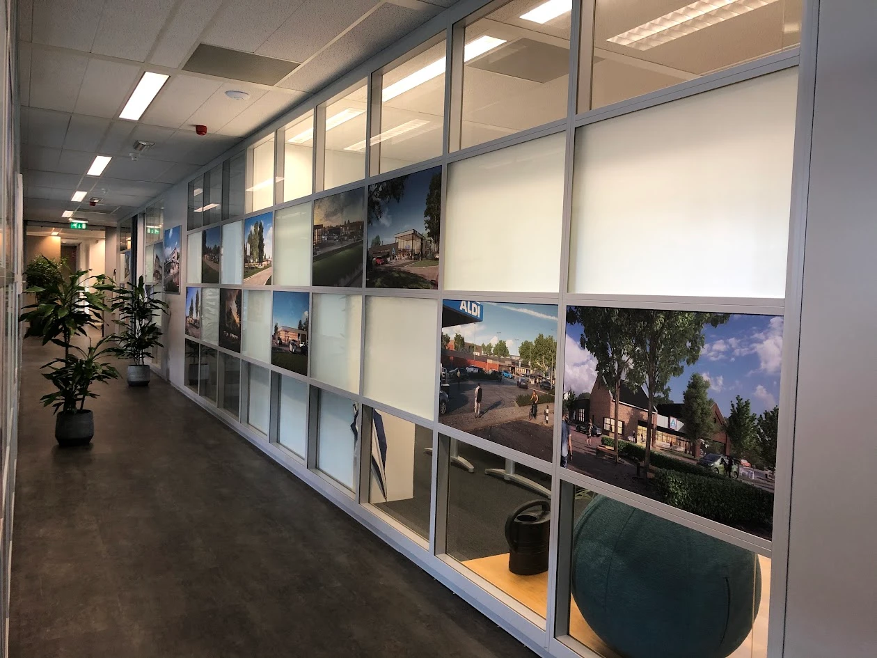 Office corridor with frosted panels, photographs of buildings and clear strips of glass