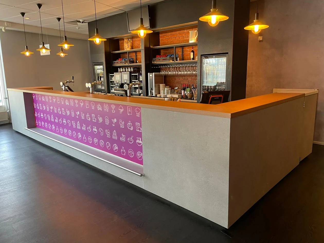 Our project photo of a hospitality counter with a wood-look top, grey finish and printed front