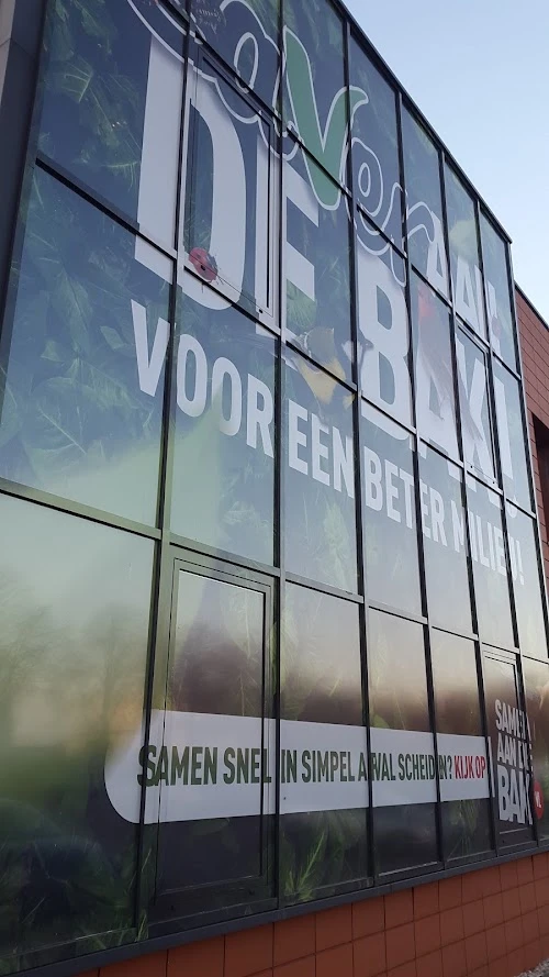 Building facade with large advertising lettering on One Way Vision film