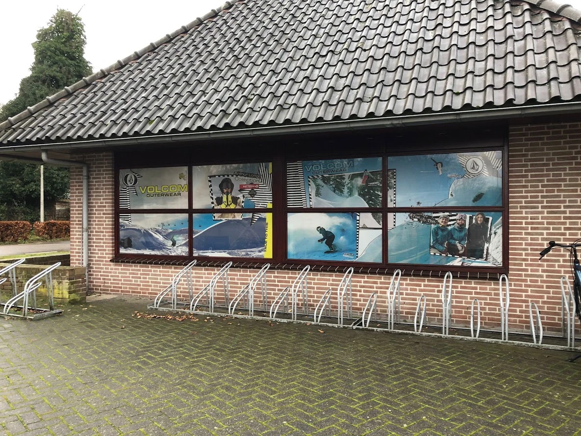 Shop windows with continuous full-colour winter sports graphics on One Way Vision film