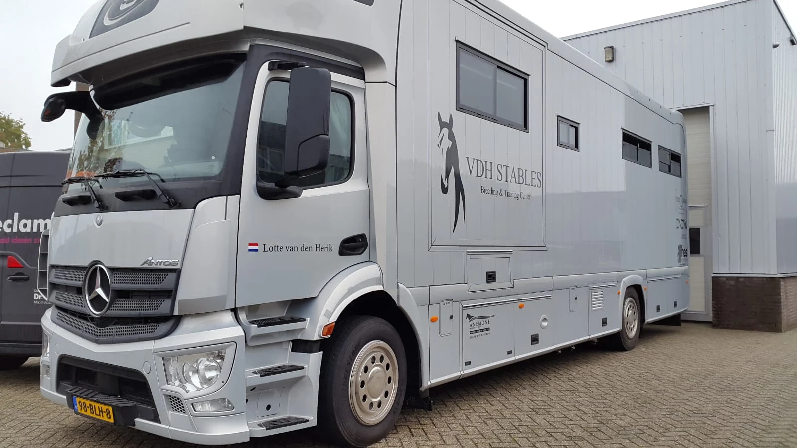 White VDH Stables horsebox with logo and lettering