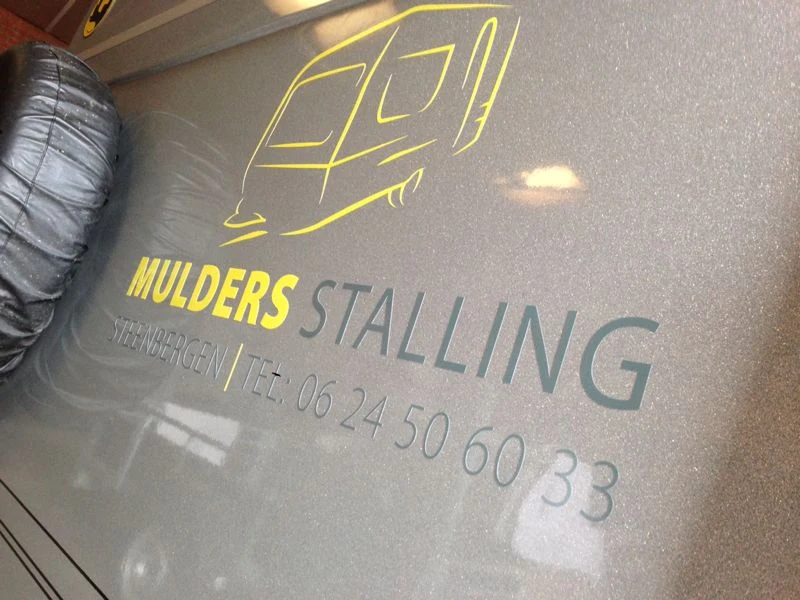Detail of Mulders Stalling lettering on a metallic horse trailer