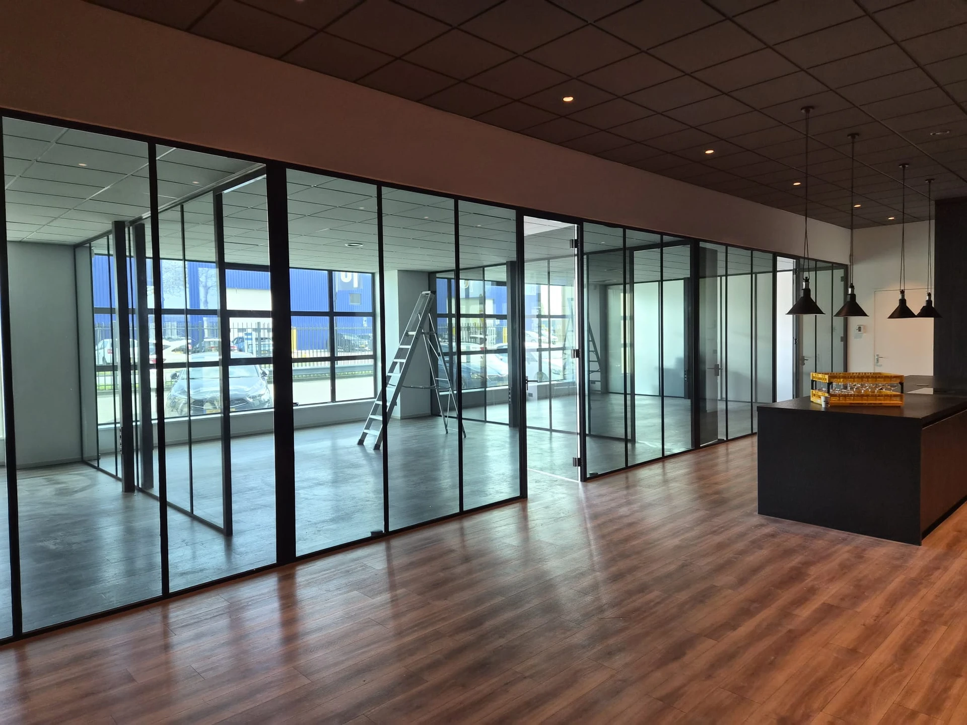 Overzicht van een kantoorinterieur met smoke glasfolie op glazen scheidingswanden