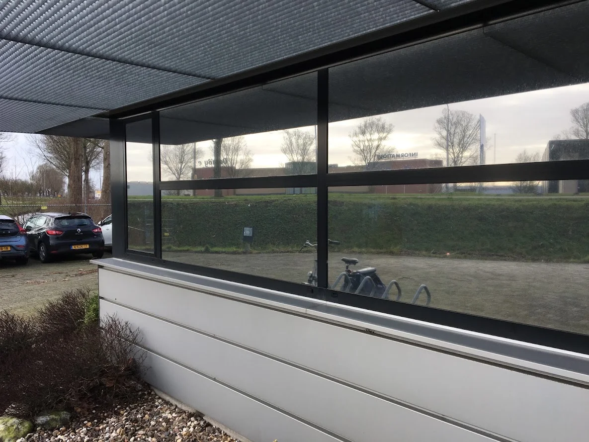 Installed reflective window film on the glazed facade of business premises