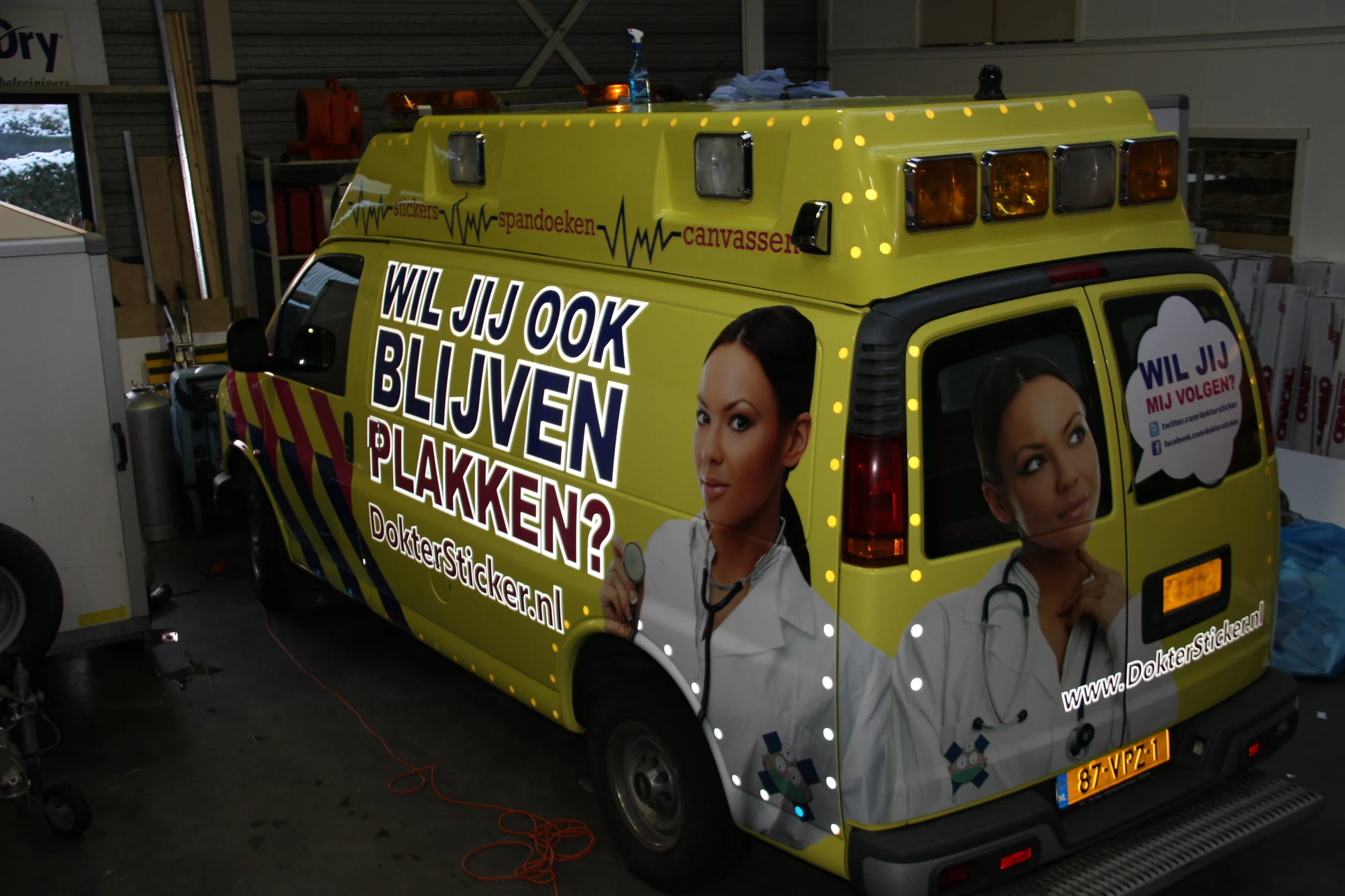Yellow DokterSticker promotional vehicle with portraits and advertising graphics