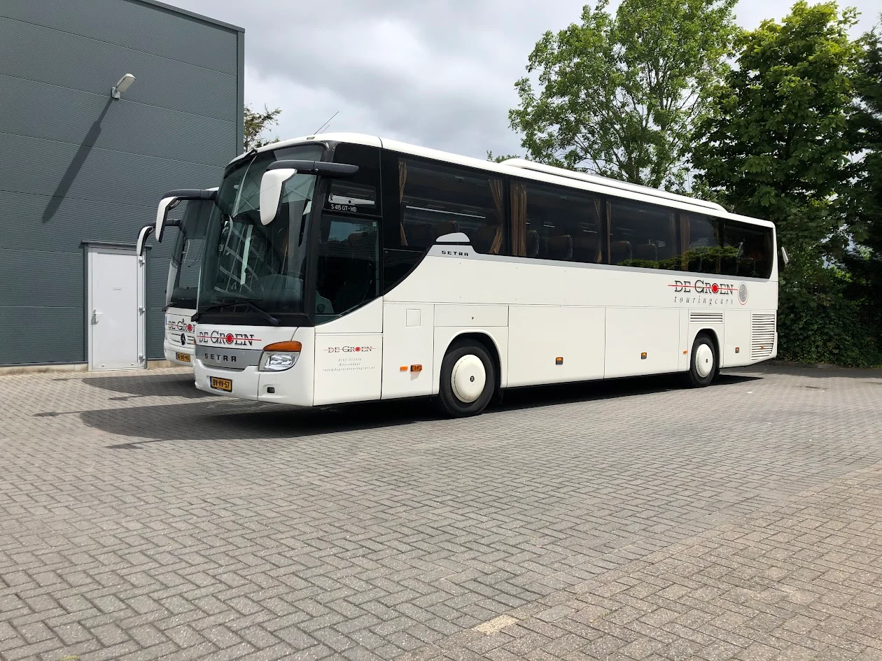 White De Groen coach with company logo and lettering