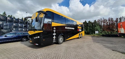 Jumbo-Visma coach outdoors with sponsor lettering