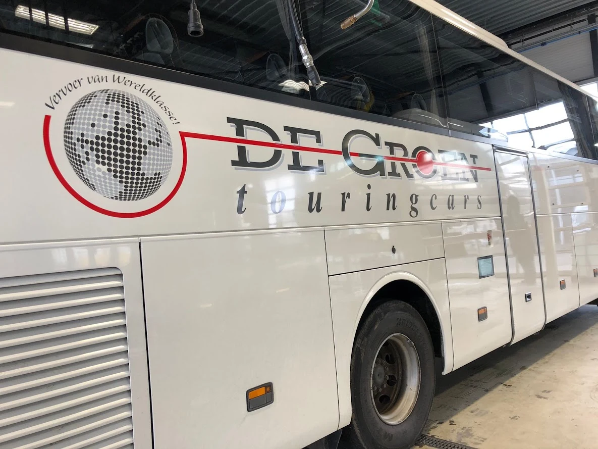 Detail of the De Groen touringcars logo on the side of a coach