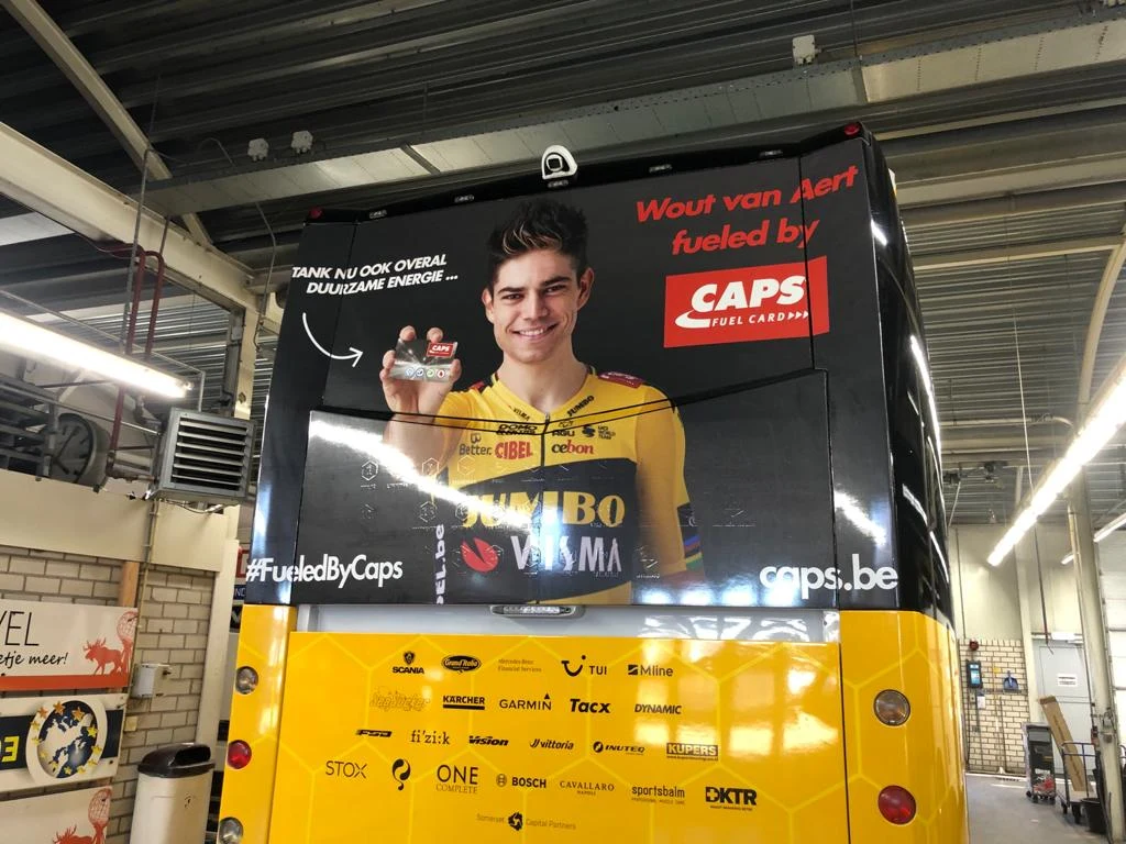 Rear of a team coach with a full-colour CAPS campaign graphic