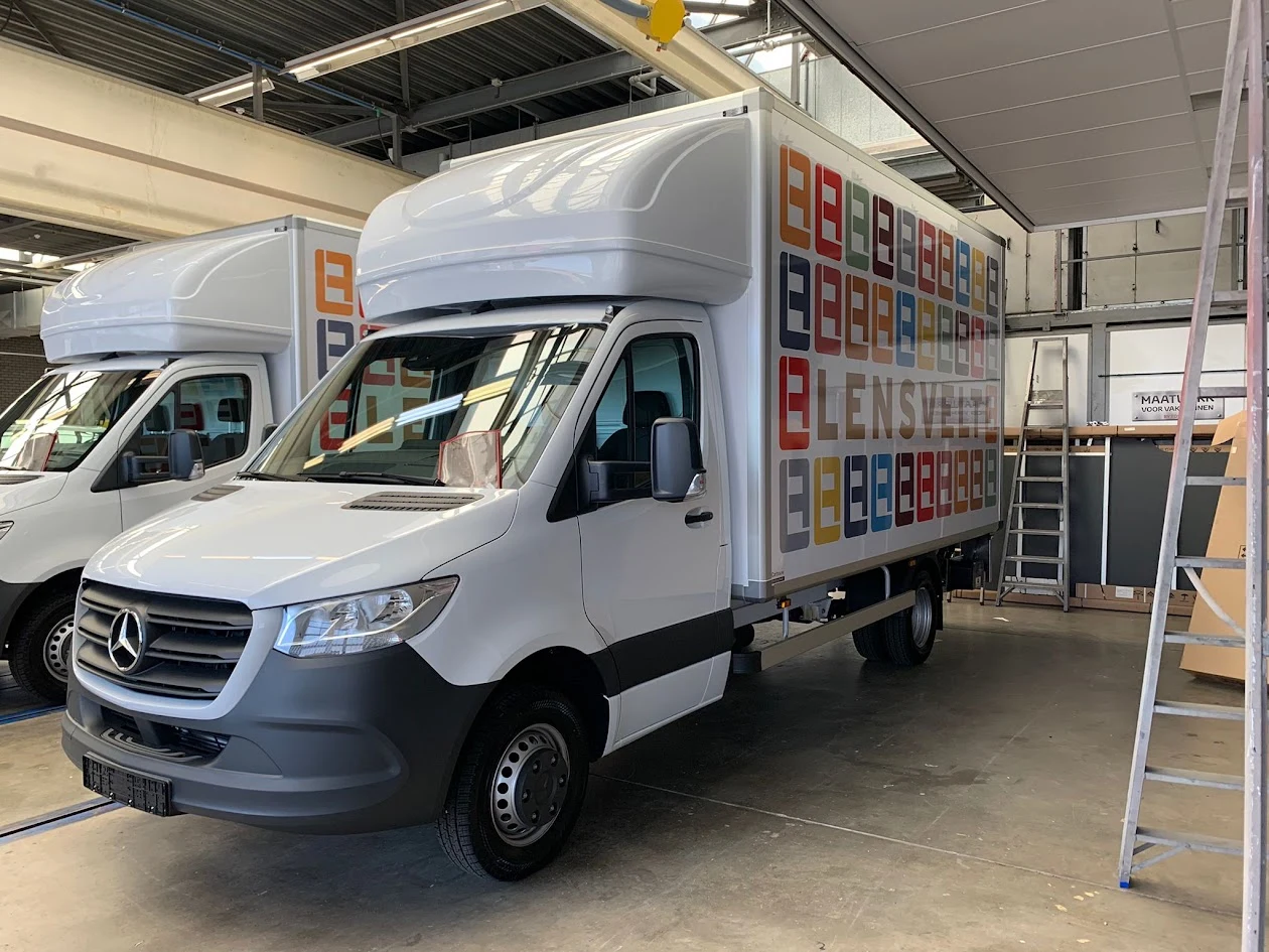White box van with colourful Lensvelt lettering