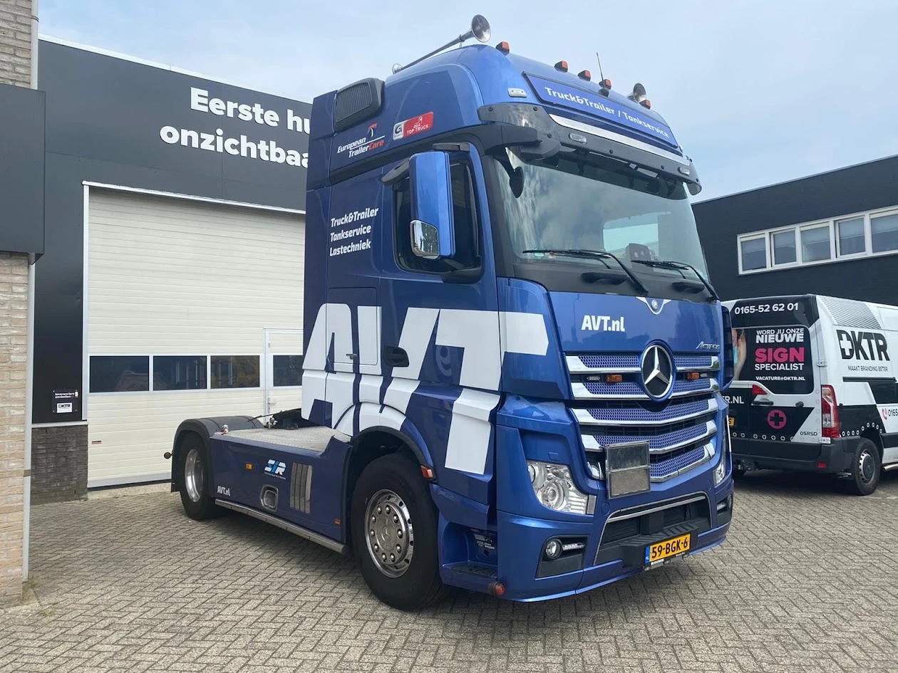 Blue AVT lorry cab with large white lettering
