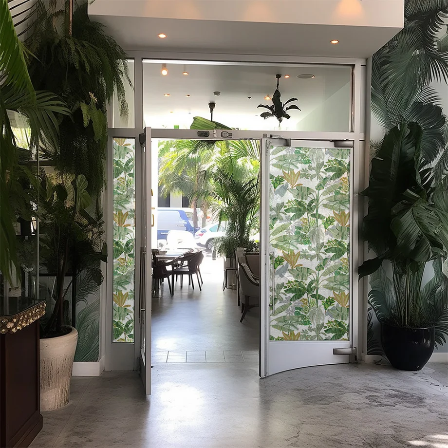 Botanical window print on glass doors in a green interior