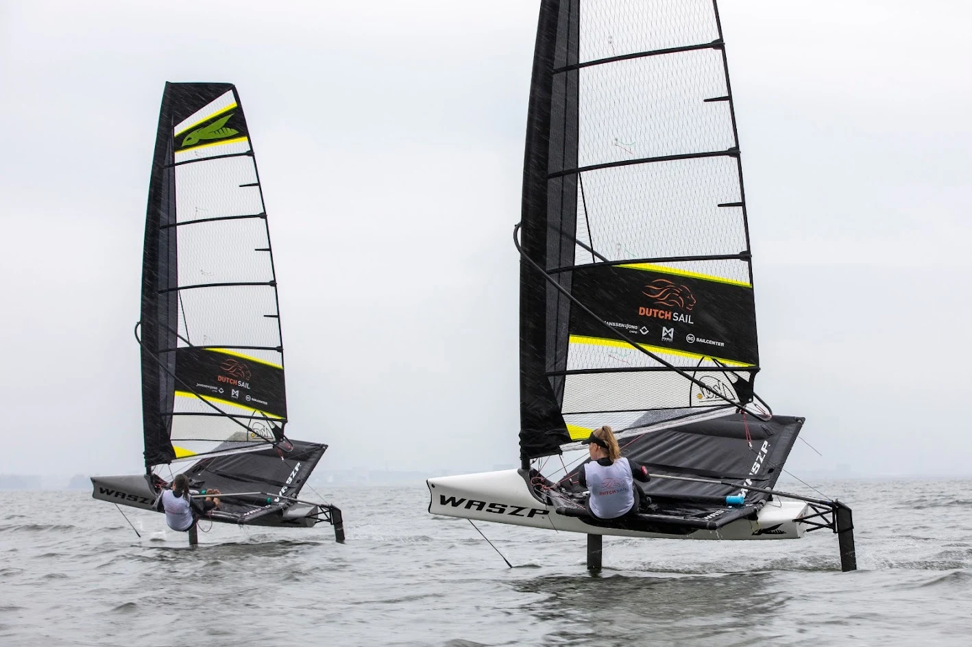 Two WASZP sailing boats with DutchSail sponsor graphics on their sails