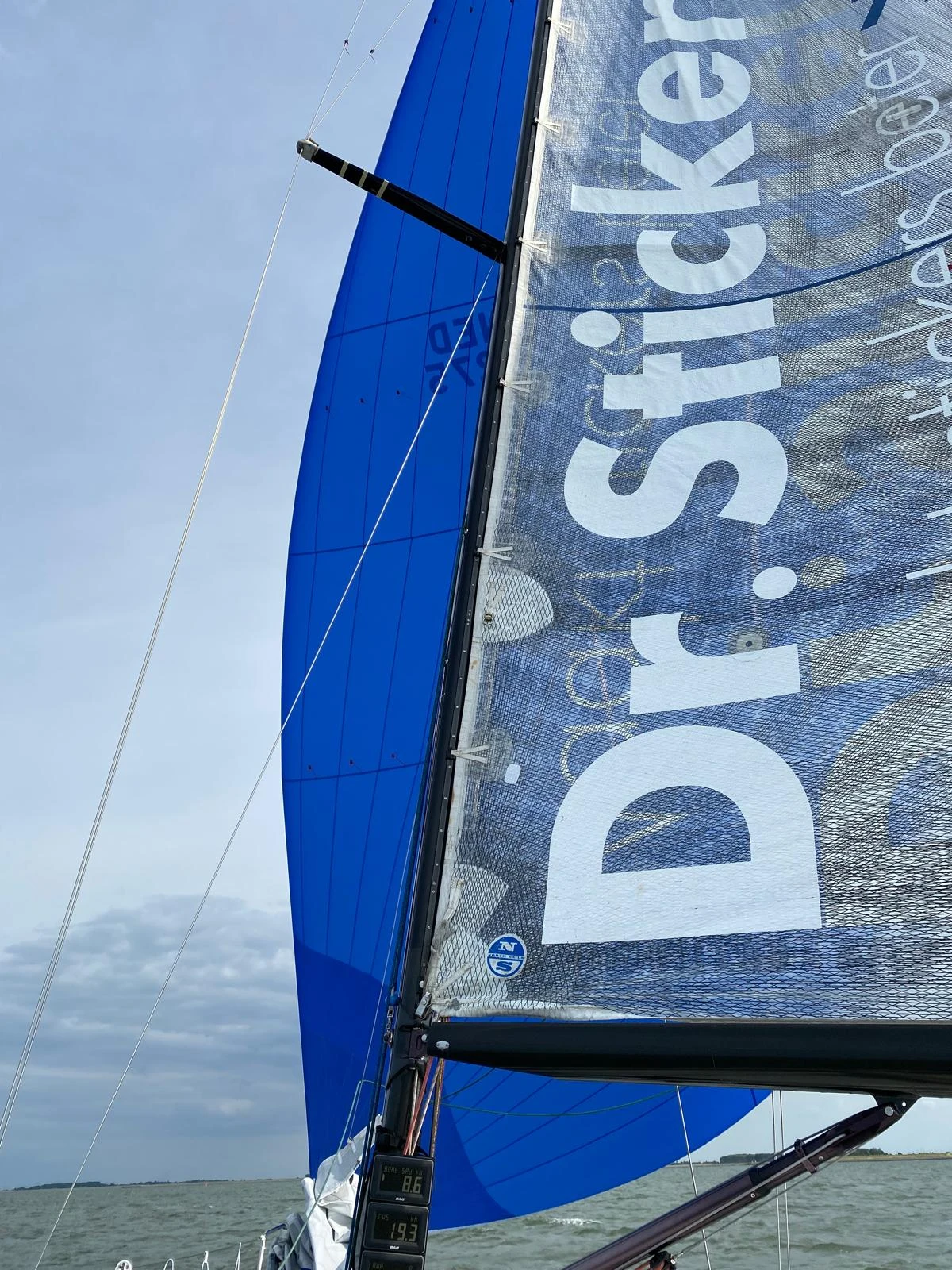 Detail of white Dr.Sticker lettering on a technical sail