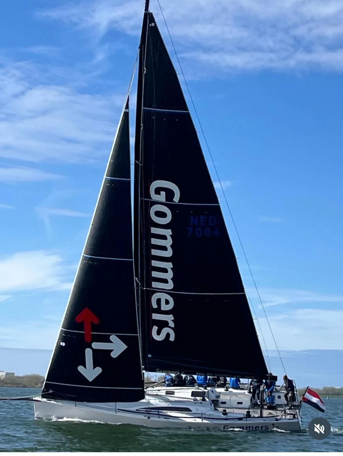 Sailing yacht with Gommers lettering and red and white arrows on its sails